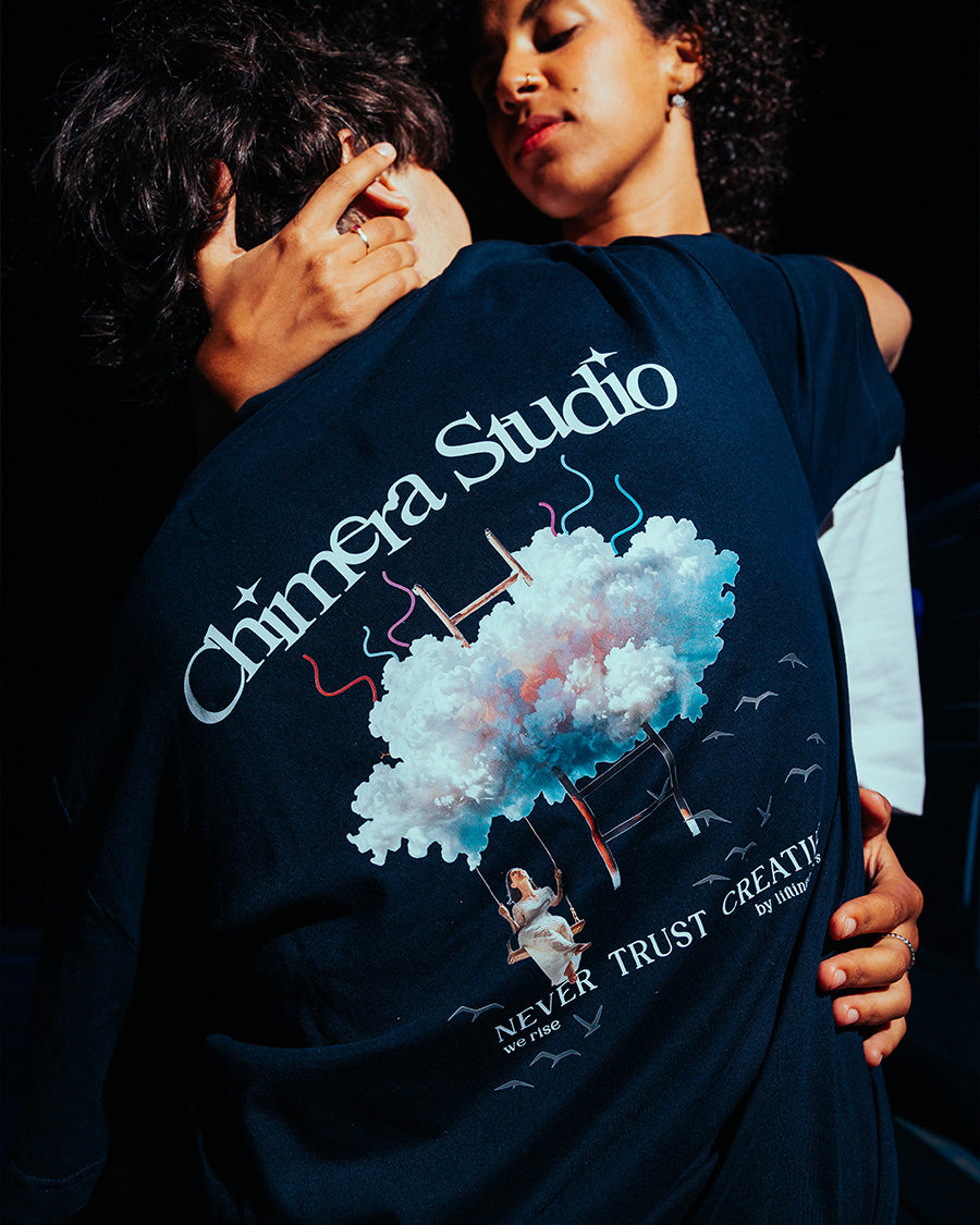 Person wearing a navy blue sweatshirt with 'Chimera Studio' design and text.