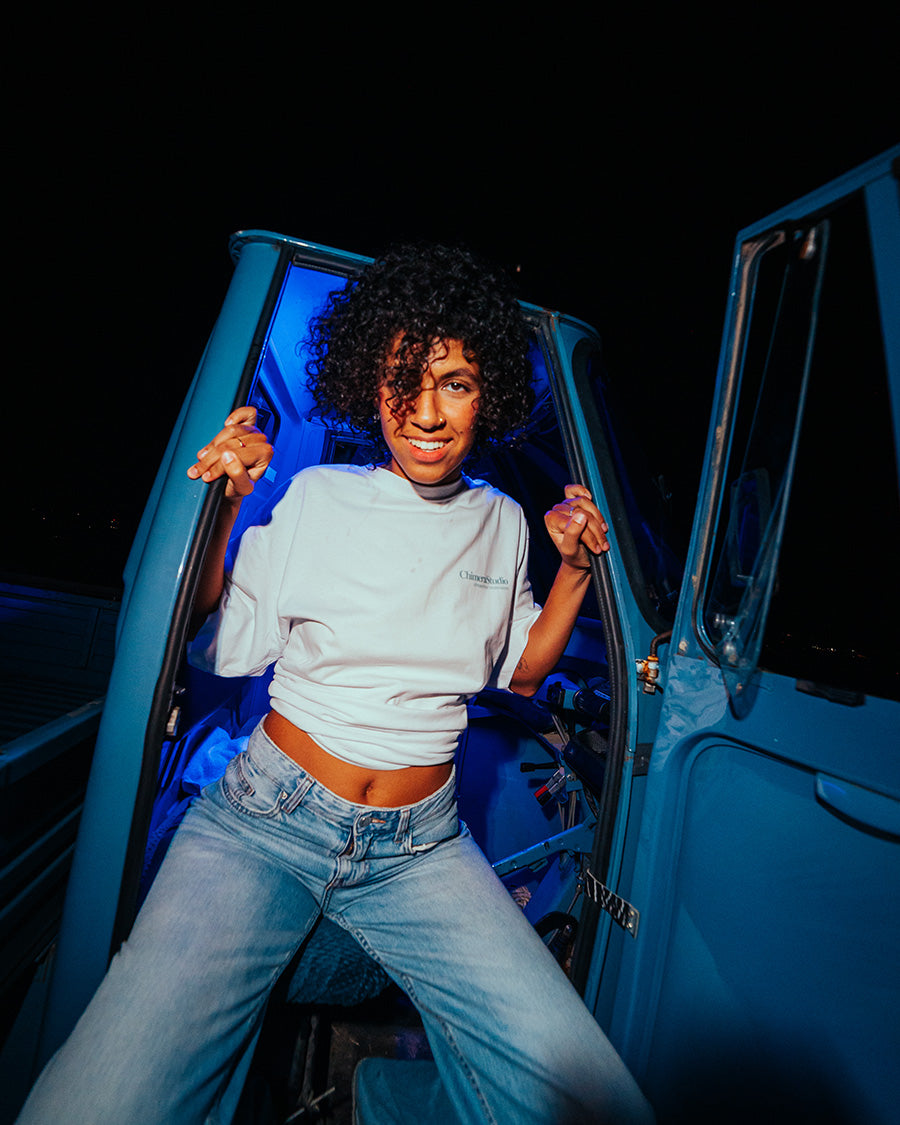 Person sitting in an open car door at night